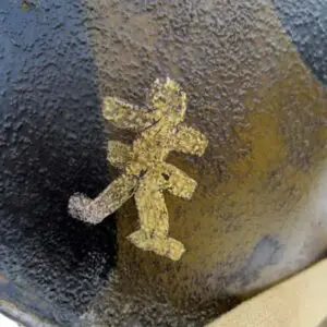 A close up of the yellow and black symbol on a metal surface.