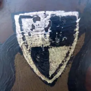 A close up of the shield on a painting