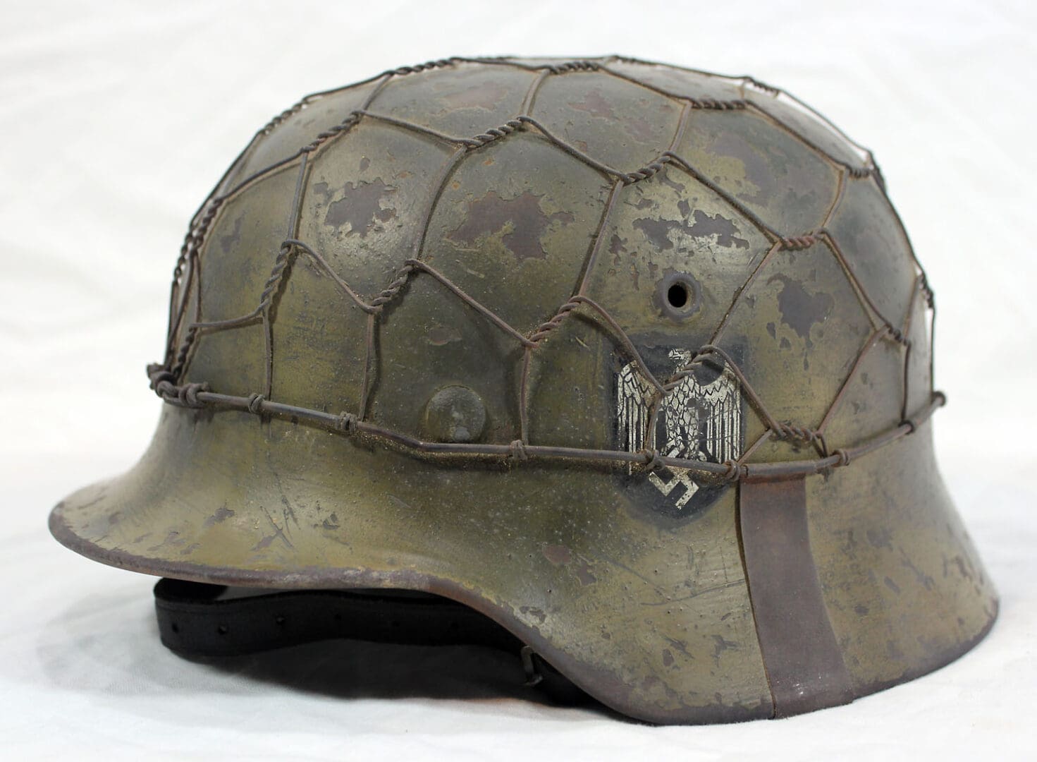 A helmet with a leather strap around the top of it.