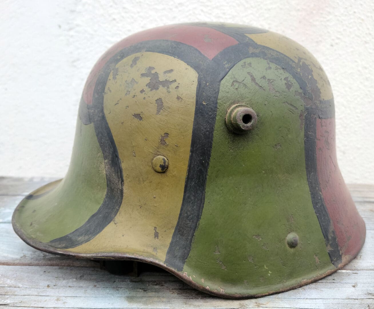 A german helmet with a painted design on it.