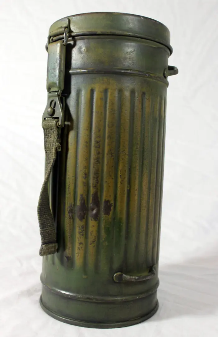 A green metal container with a strap around it.